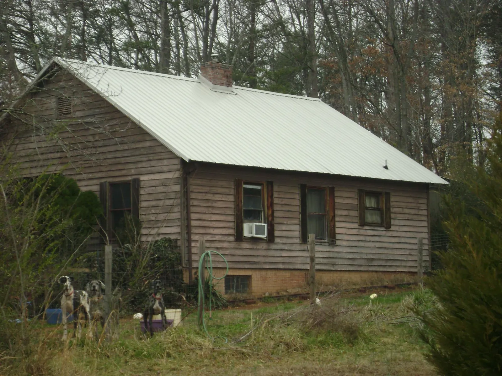 White metal roof on an old wood sided farmhouse, from a Metal Roof Installation job in Monaca